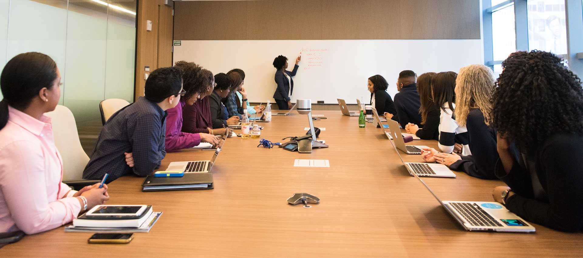 Businesswoman giving presentation explains new plan at meeting