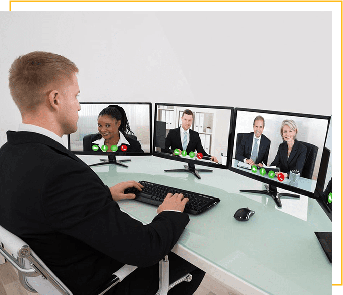 Businessman video conferencing with team on computer at desk in office